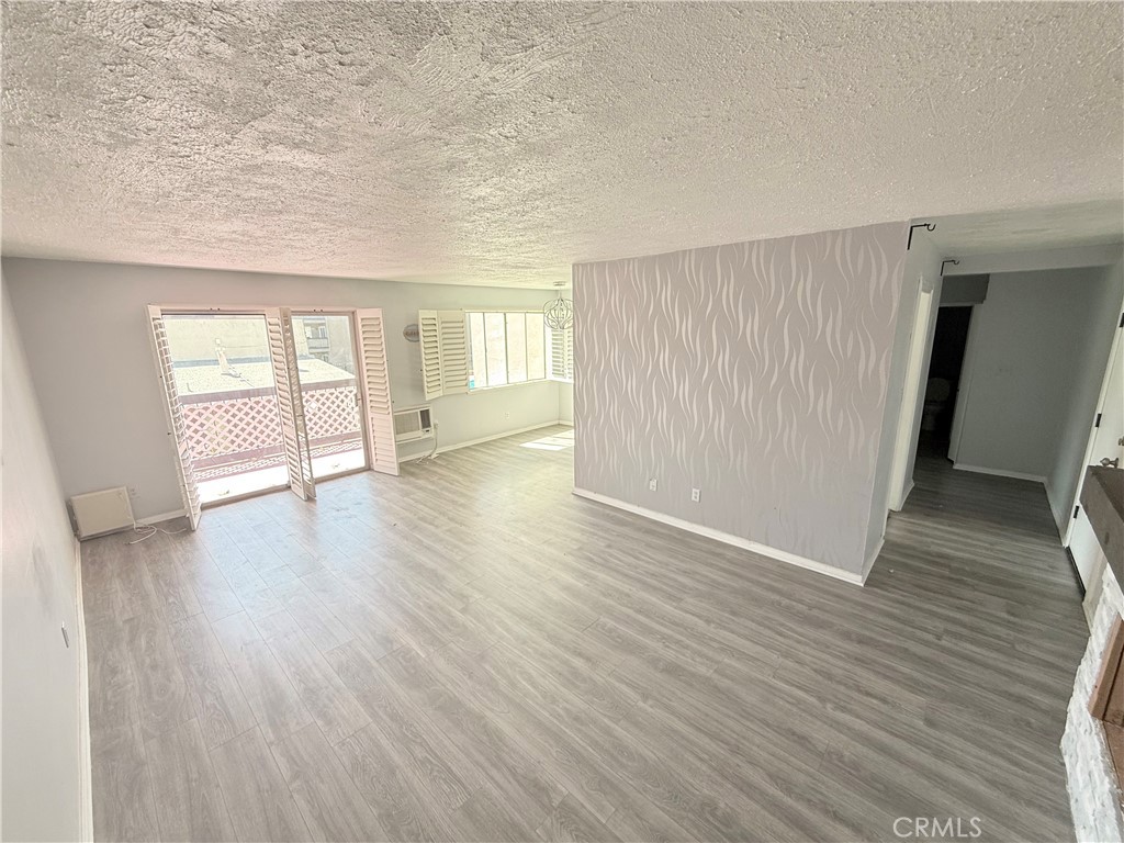 12200 Montecito Road, Unit D221 Seal Beach, CA 90740 - Photo 4 of 25 Living with slider leading to balcony