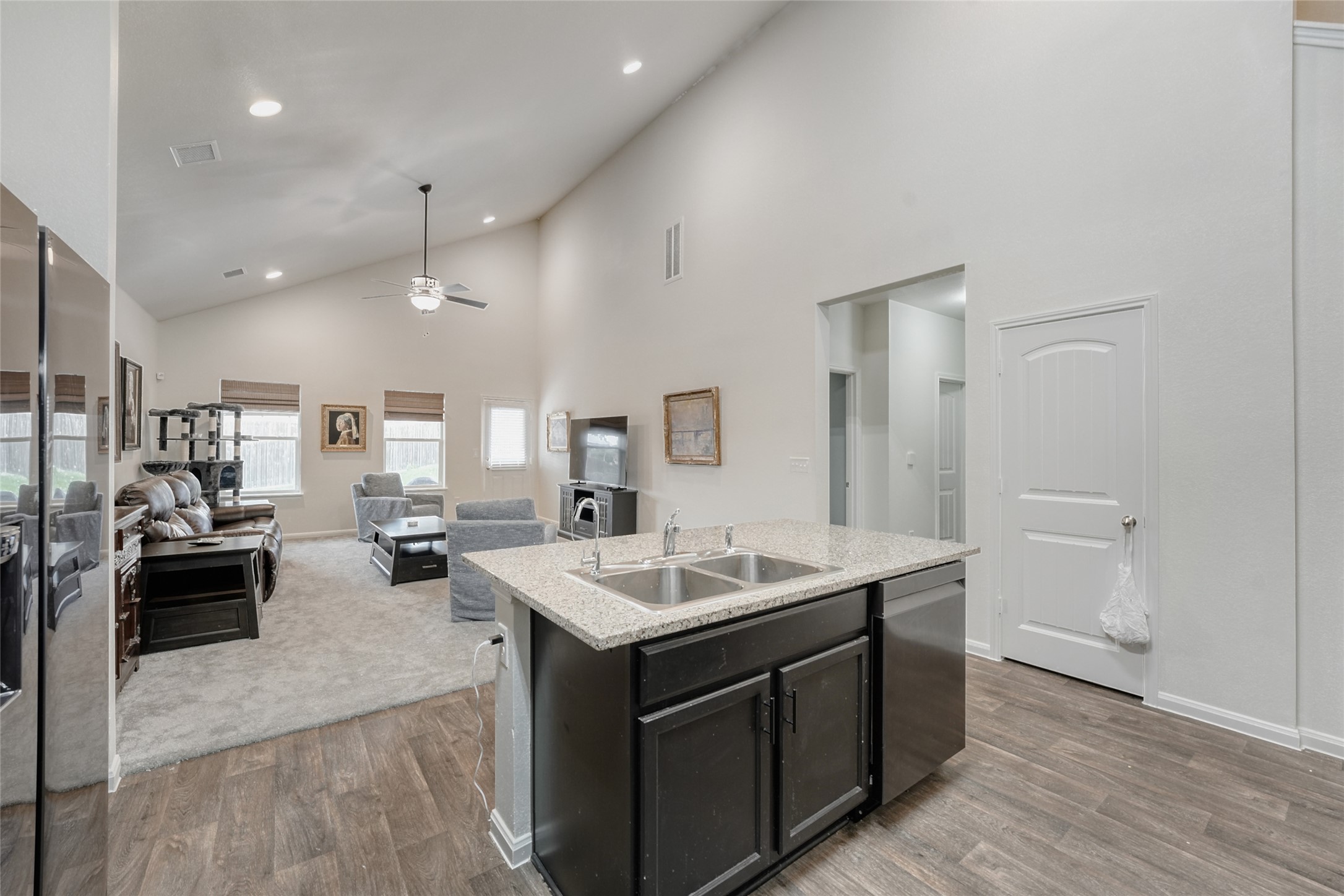 15105 Shell Bark Cove Austin, TX 78724 - Photo 27 of 30 An open floorplan seamlessly connects the kitchen and living areas, highlighted by soaring vaulted ceilings.