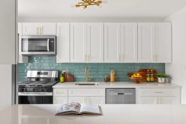a kitchen with a sink stove and cabinets