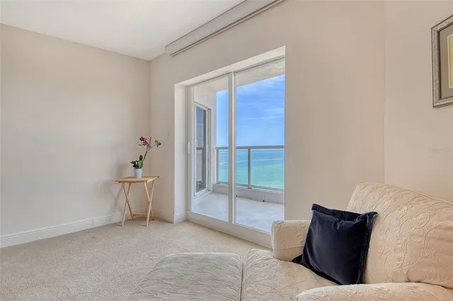 a view of a kitchen from the hallway with a sink and wooden floor