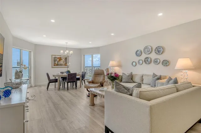 a view of a dining room with furniture wooden floor and a chandelier