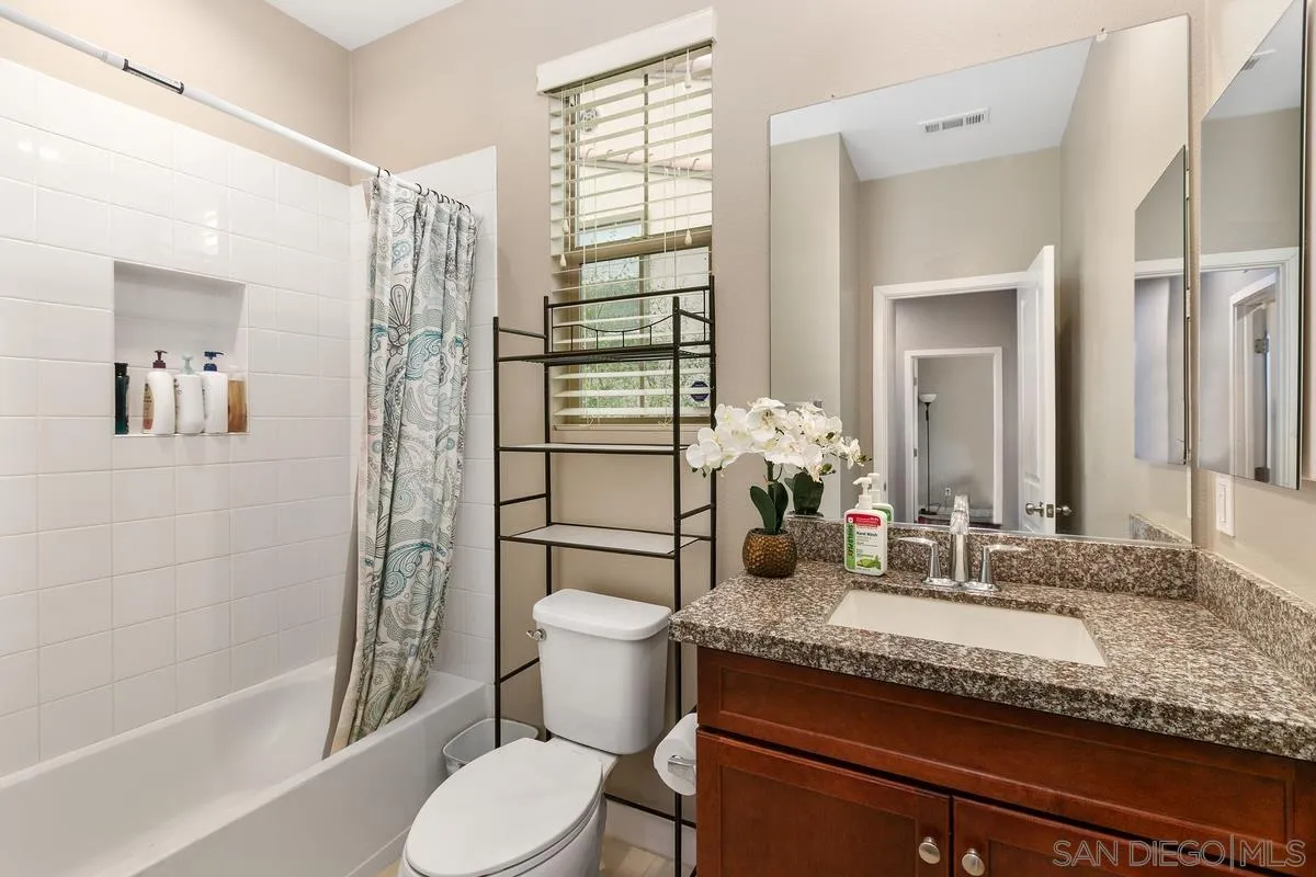 7508 Eagle Drive Santee, CA 92071 - Photo 14 of 22 a bathroom with a granite countertop sink toilet and shower