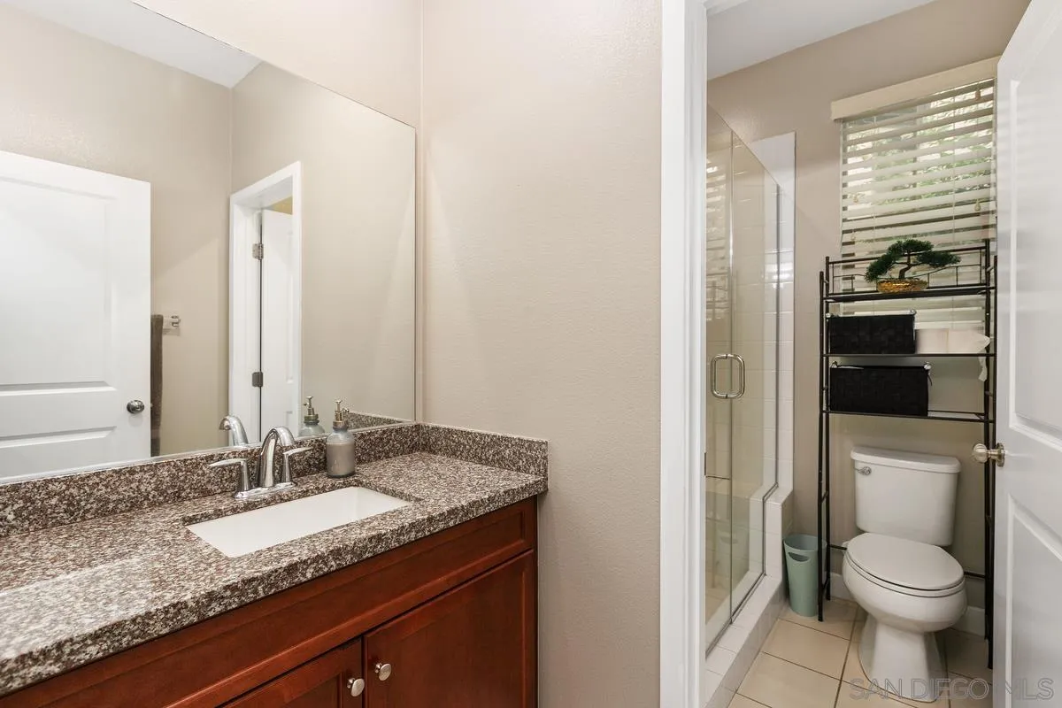 7508 Eagle Drive Santee, CA 92071 - Photo 17 of 22 a bathroom with a granite countertop sink toilet and shower