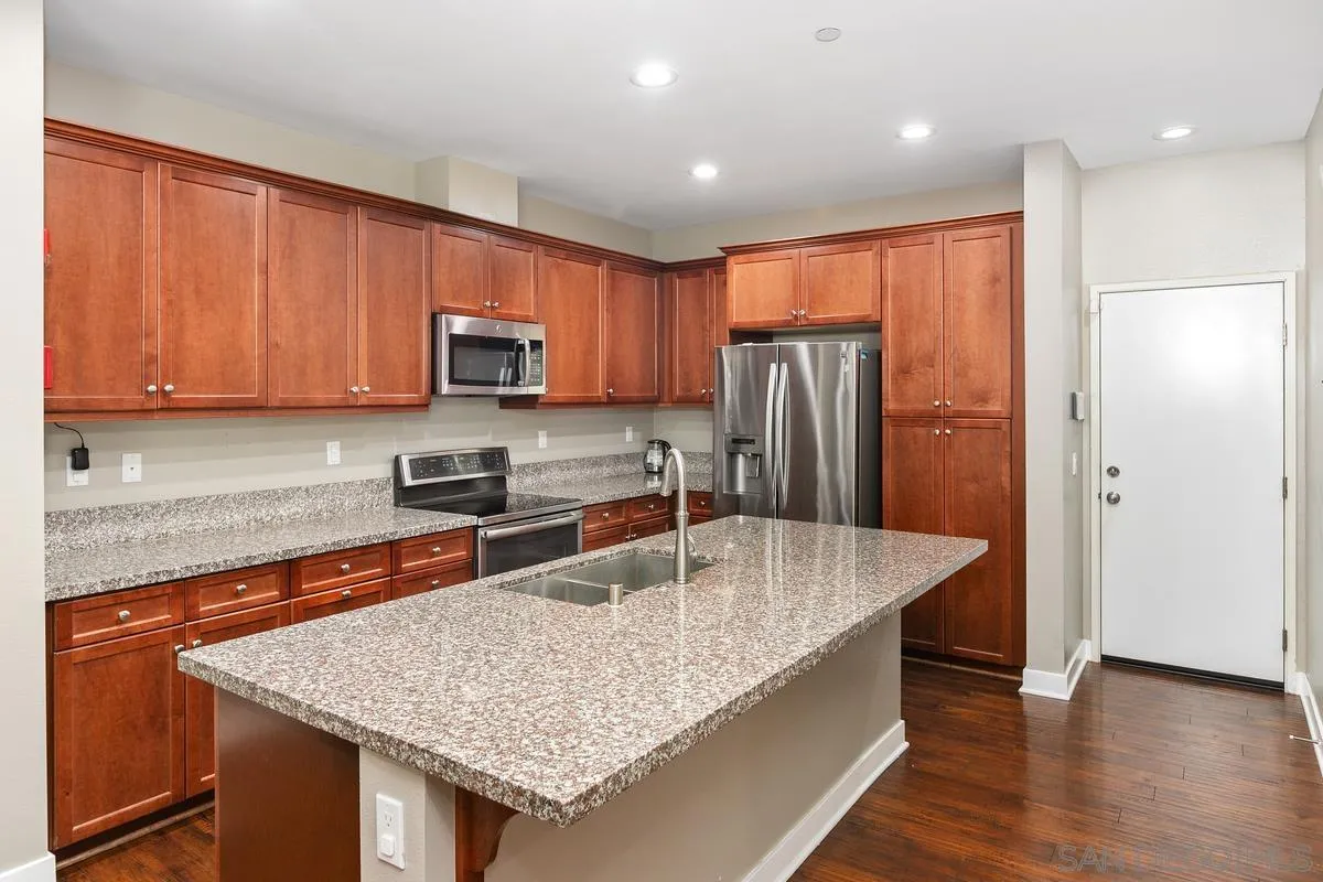 7508 Eagle Drive Santee, CA 92071 - Photo 5 of 22 a kitchen with stainless steel appliances granite countertop refrigerator sink microwave and stove
