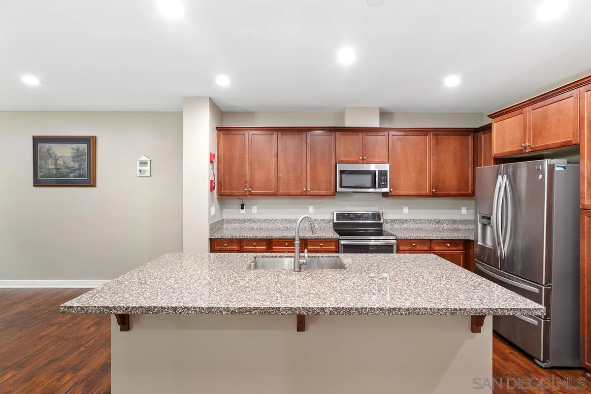 7508 Eagle Drive Santee, CA 92071 - Photo 7 of 22 a kitchen with granite countertop stainless steel appliances and wooden cabinets