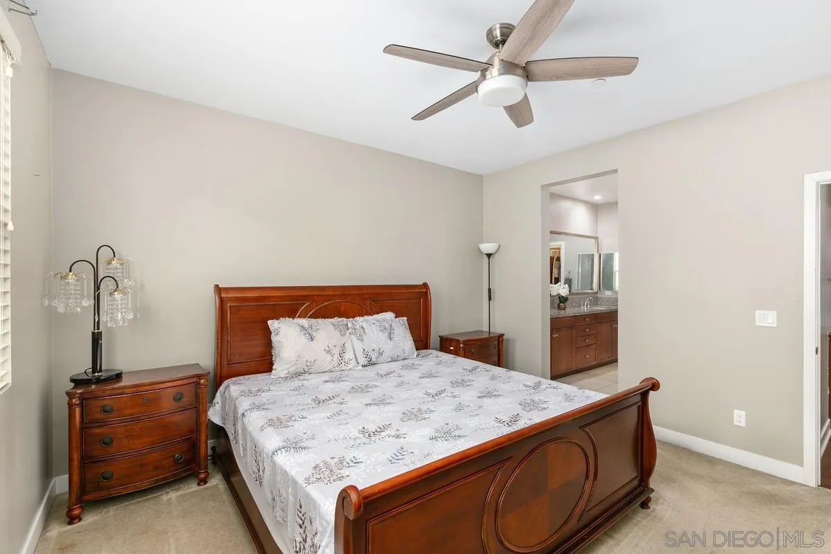 7508 Eagle Drive Santee, CA 92071 - Photo 9 of 22 a bedroom with a bed and ceiling fan