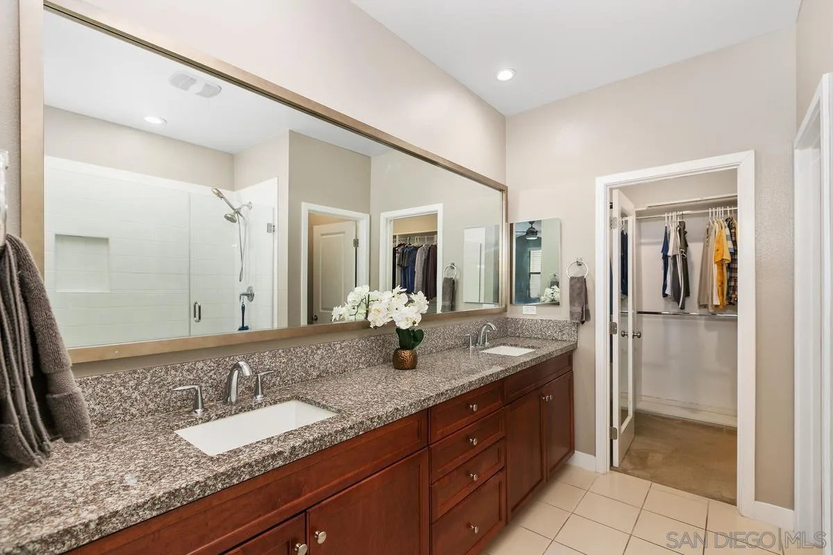7508 Eagle Drive Santee, CA 92071 - Photo 10 of 22 a bathroom with a granite countertop sink and a mirror
