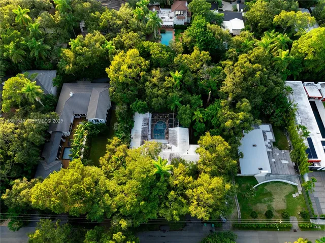 an aerial view of a house with a yard and garden