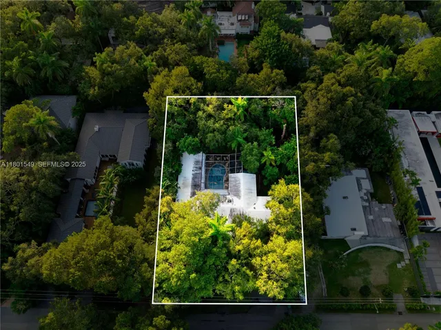 an aerial view of a house with pool outdoor seating and yard