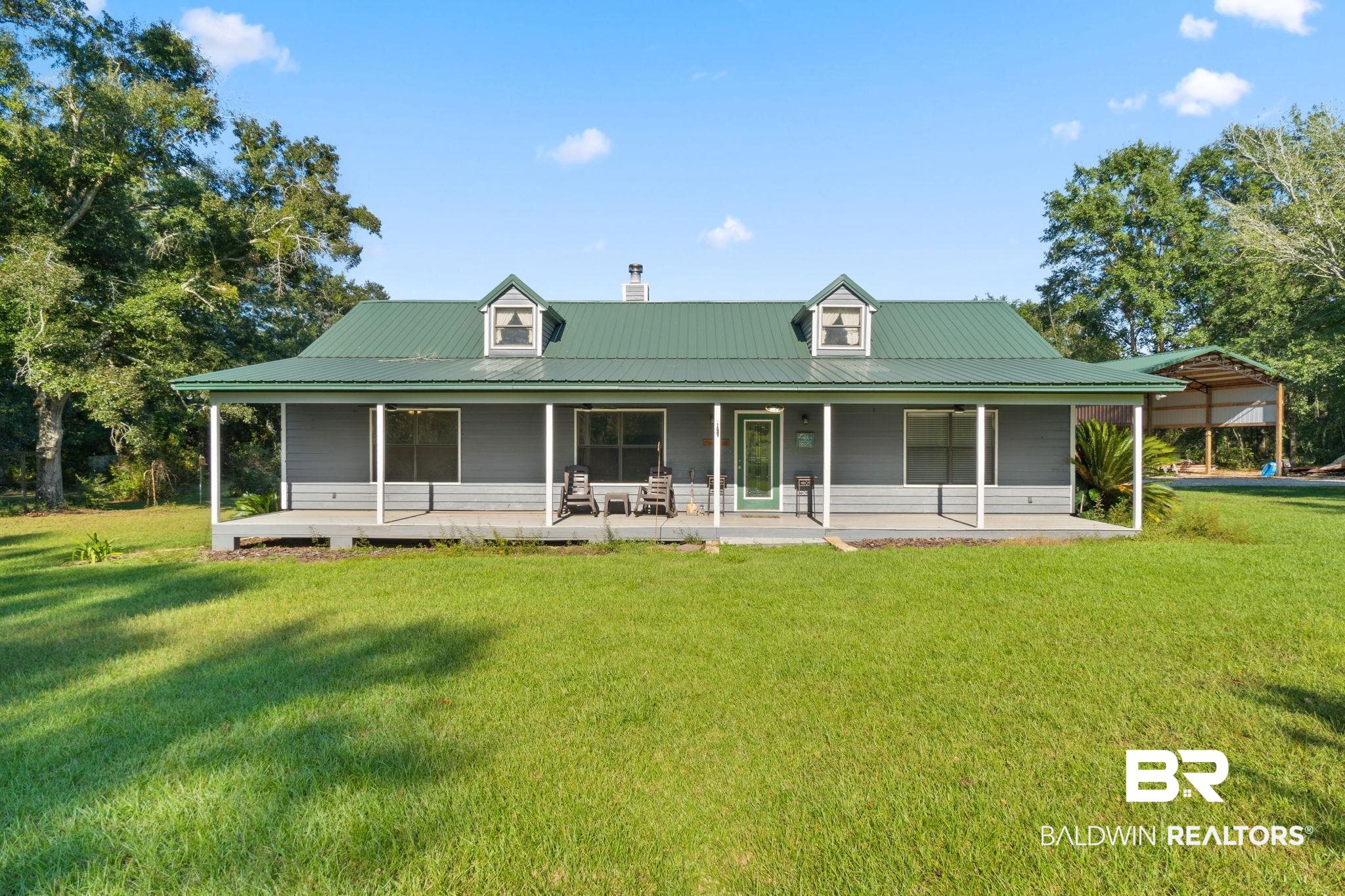 27300 C R Watson Road Robertsdale, AL 36567 - Photo 2 of 35 Rear view of house with a lawn and covered porch