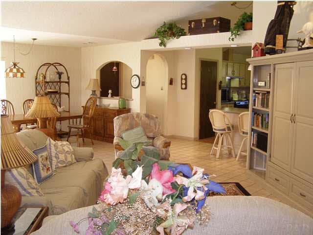 2597 Crescent Road Navarre, FL 32566 - Photo 6 of 22 The great room has cathedral ceiling with lots of plant ledges.