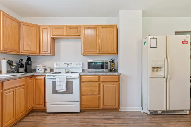 a bedroom with a bed and a flat tv screen on dresser