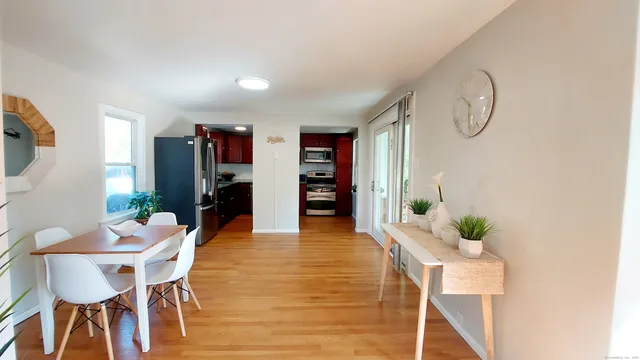 a dining room with furniture and wooden floor