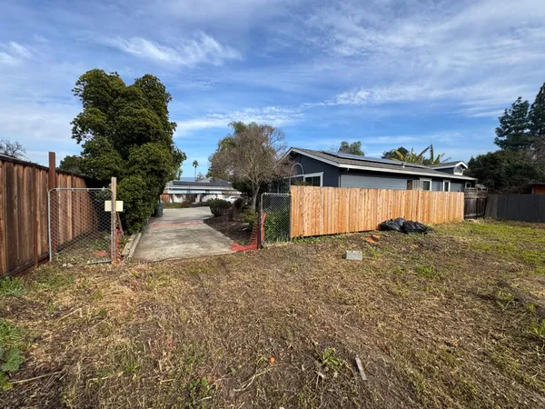 a view of a house with backyard and sitting area