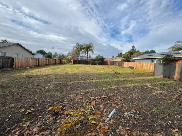 a view of a big yard with a house