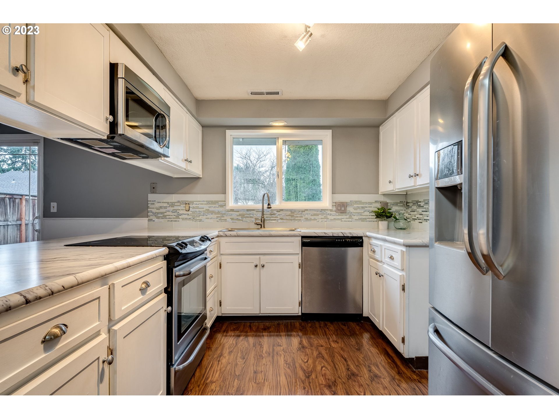 126 Villa Road Kelso, WA 98626 - Photo 13 of 41 a kitchen with granite countertop stainless steel appliances a stove sink and microwave