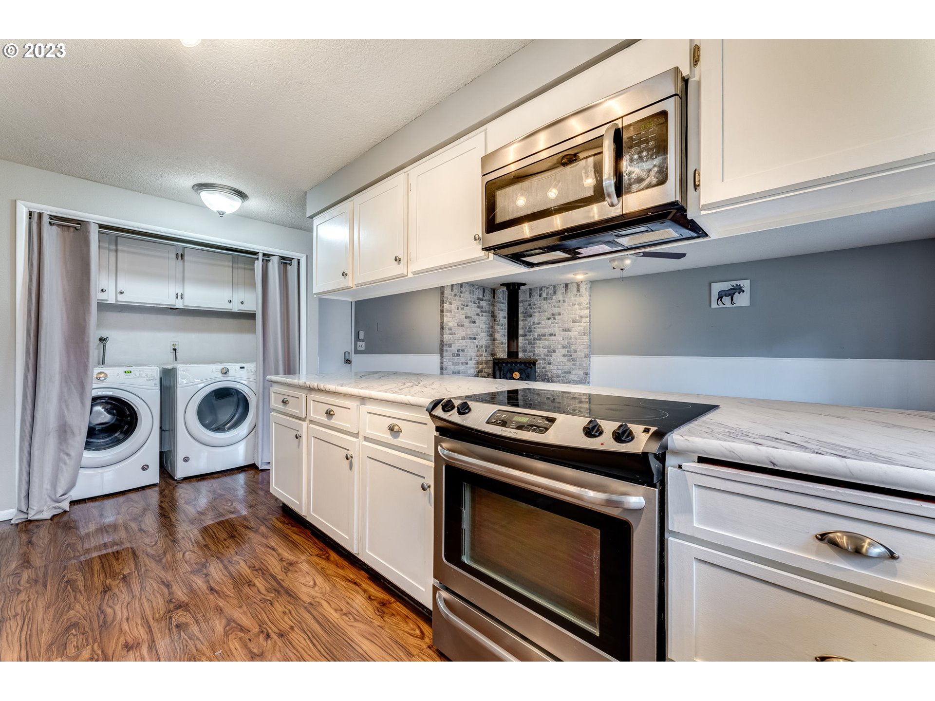 126 Villa Road Kelso, WA 98626 - Photo 16 of 41 a kitchen with stainless steel appliances granite countertop a stove and a microwave