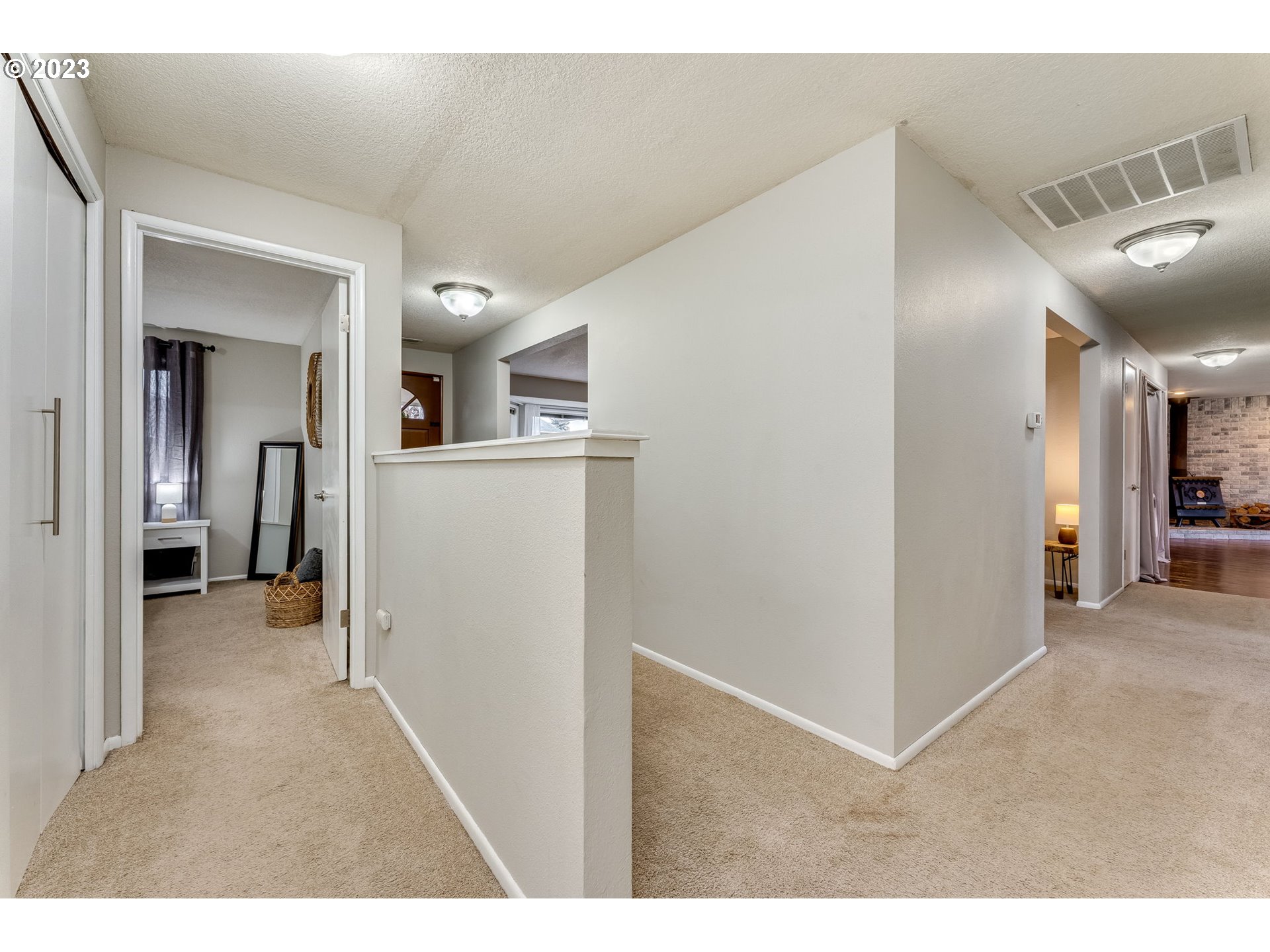 126 Villa Road Kelso, WA 98626 - Photo 23 of 41 a view of a hallway with wooden floor and a living room