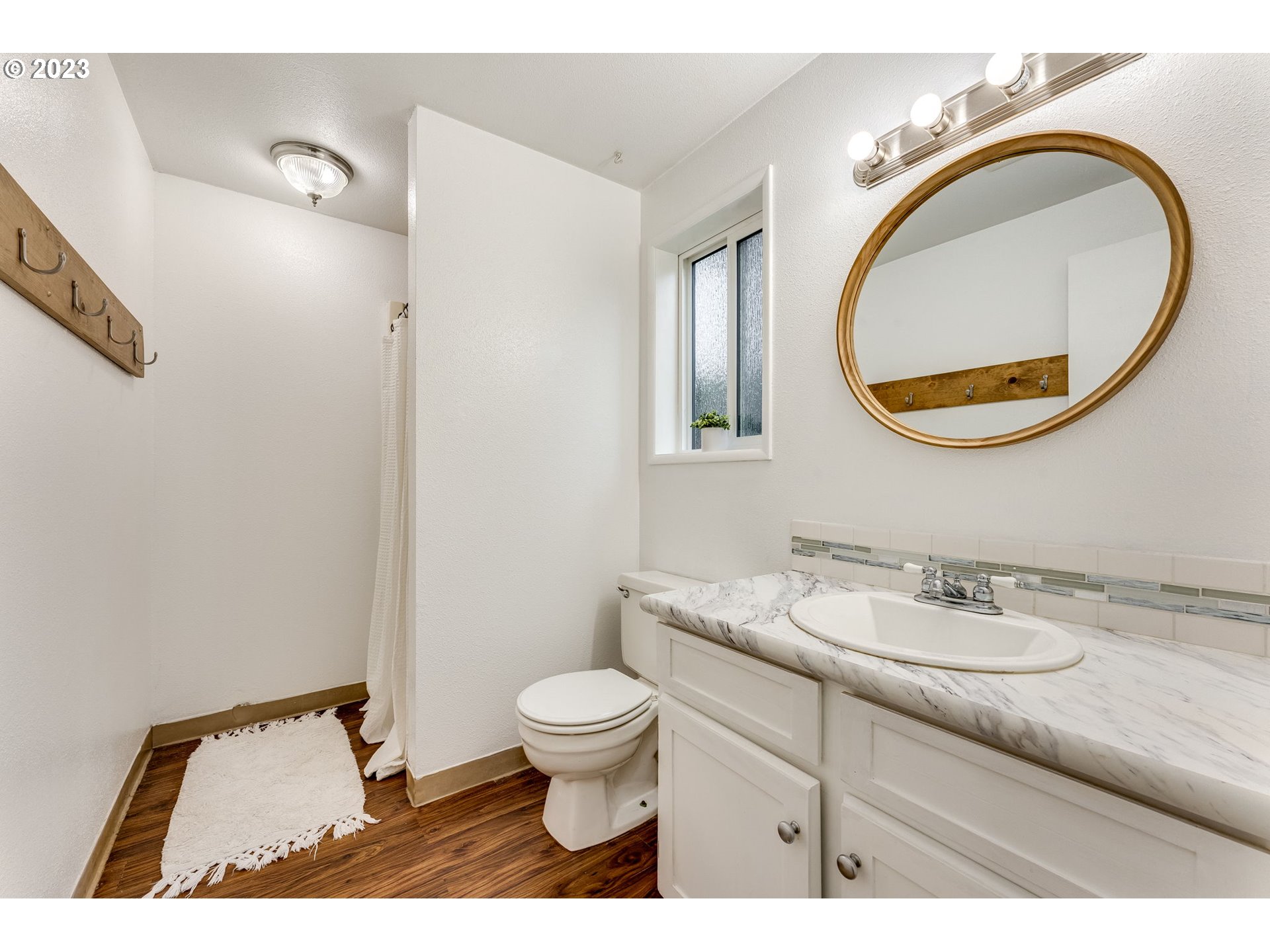 126 Villa Road Kelso, WA 98626 - Photo 26 of 41 a bathroom with a granite countertop toilet a sink and a mirror