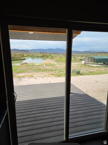 9381 South Sevier Riv Ranch Levan, UT 84639 - Photo 54 of 58 Sliding glass doors opening to an outdoor deck, a prominent body of water, and distant mountains