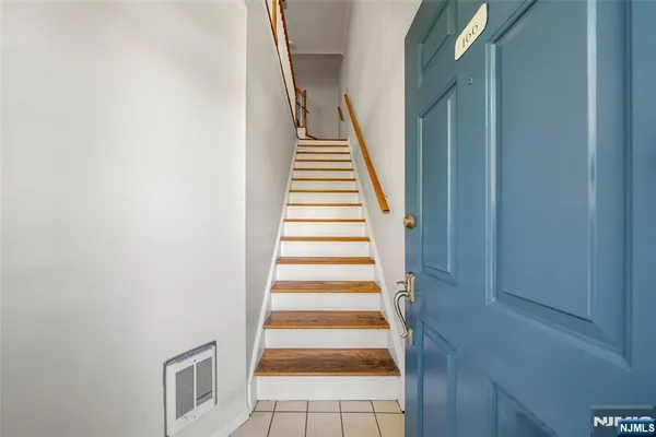 a view of a livingroom with furniture hardwood floor and staircase
