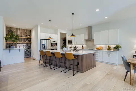 a large kitchen with lots of counter space and furniture