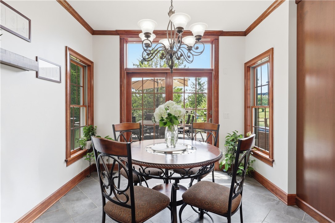 2057 Stirnie Road Victor, NY 14564 - Photo 14 of 48 Directly off the kitchen, the bright casual dining room serves as a wonderful space for daily meals. Glass sliding doors flood the area with light and open directly to the massive rear deck.