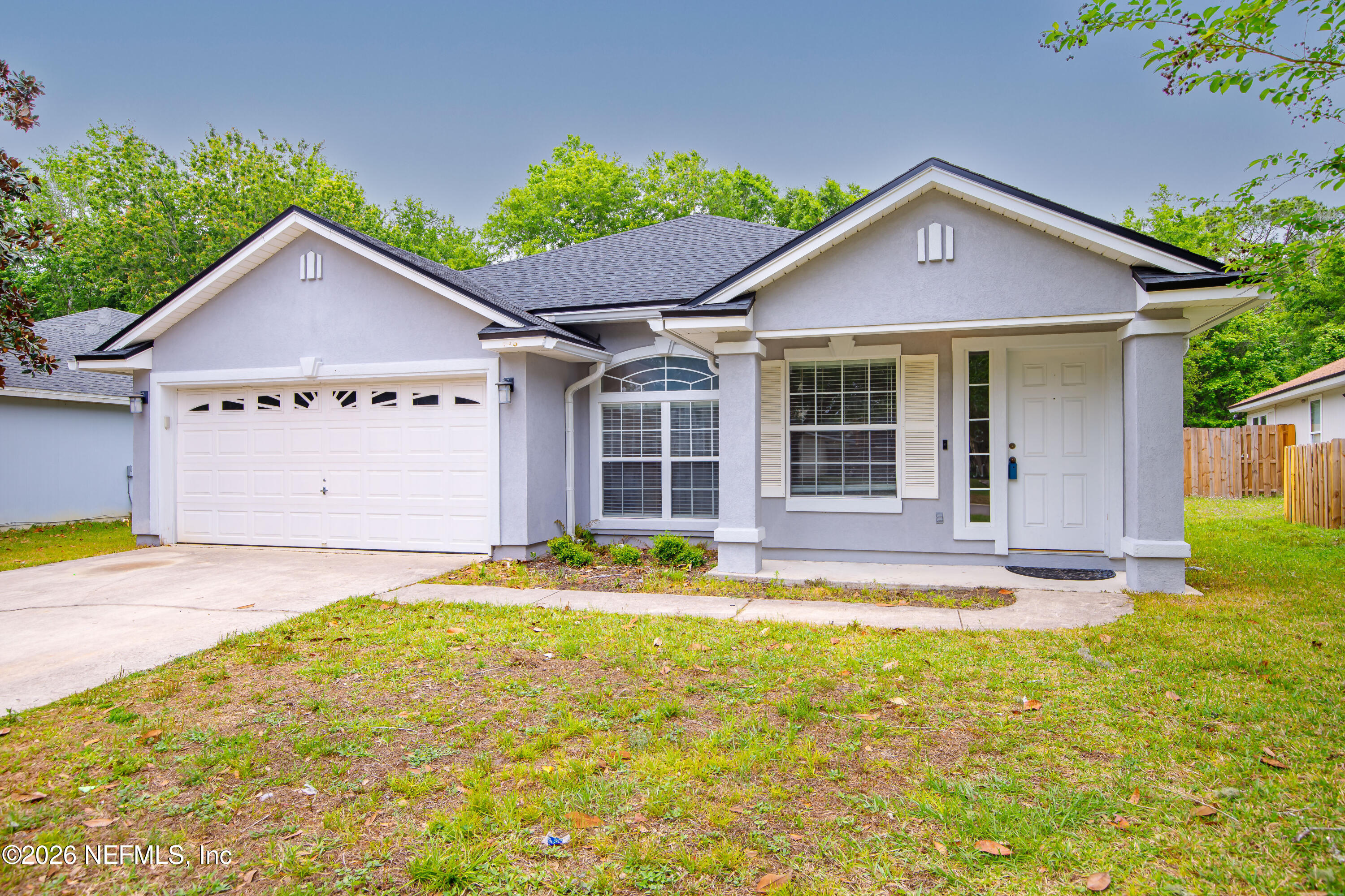 673 MacKenzie Circle St. Augustine, FL 32092 - Photo 1 of 28 a front view of a house with a yard