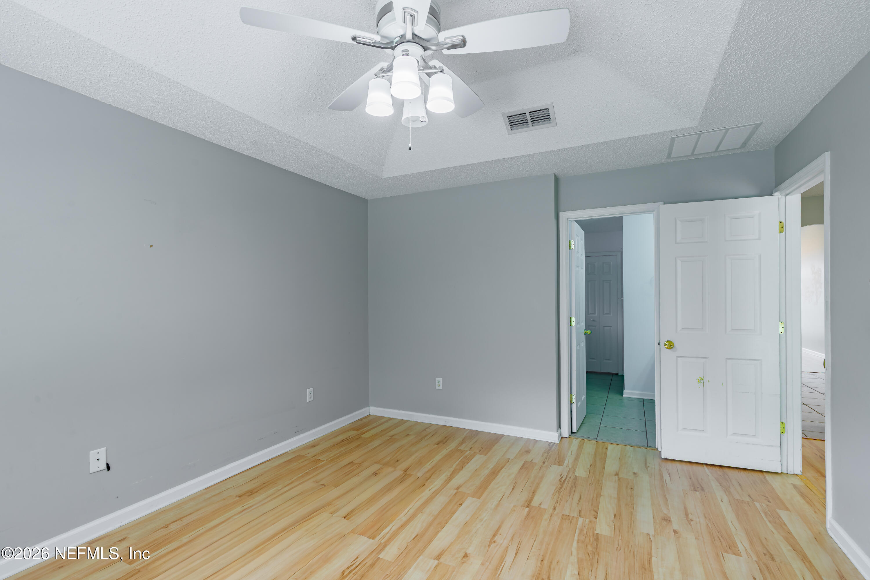 673 MacKenzie Circle St. Augustine, FL 32092 - Photo 20 of 28 wooden floor in an empty room with a window
