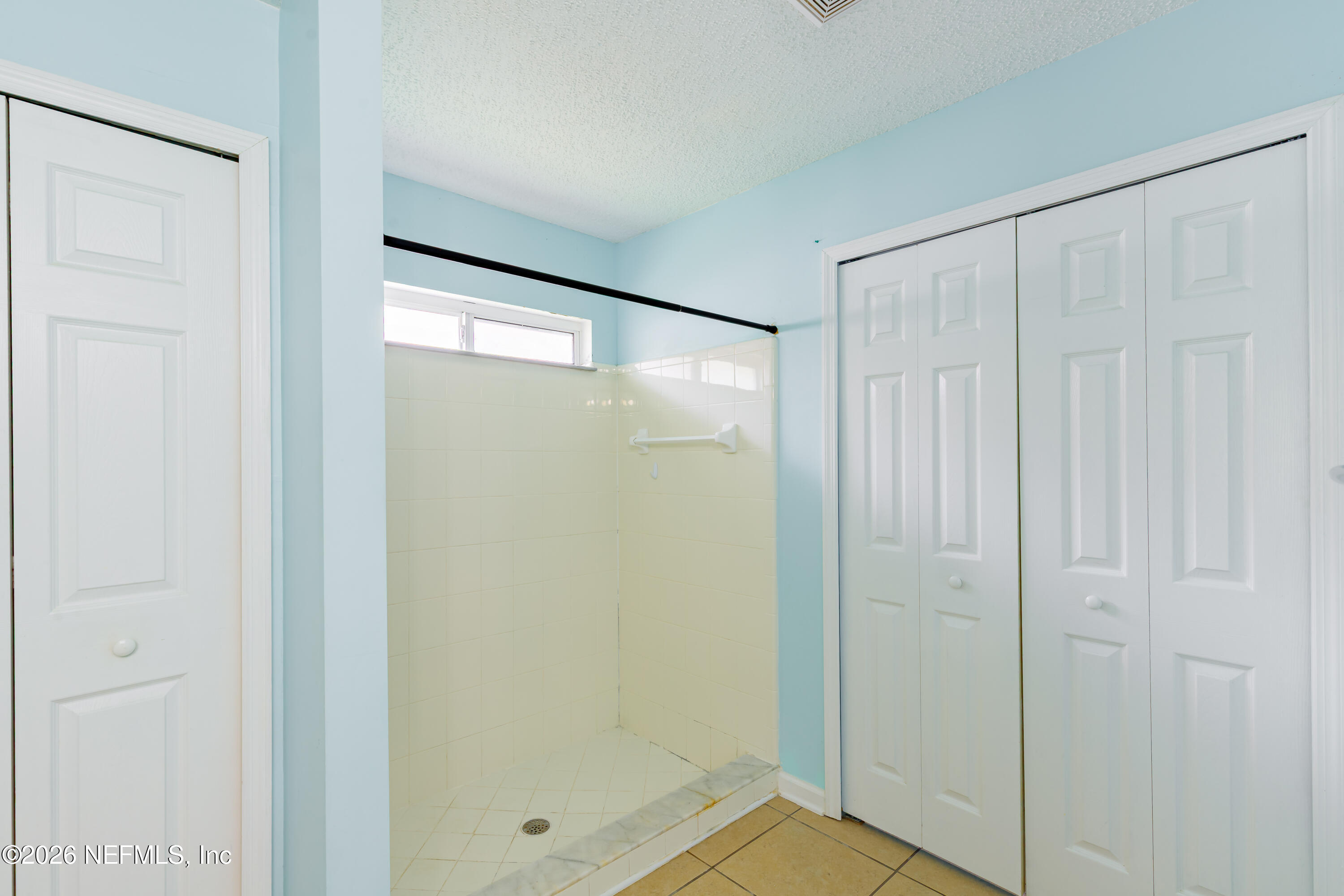 673 MacKenzie Circle St. Augustine, FL 32092 - Photo 23 of 28 a bathroom with a glass shower door