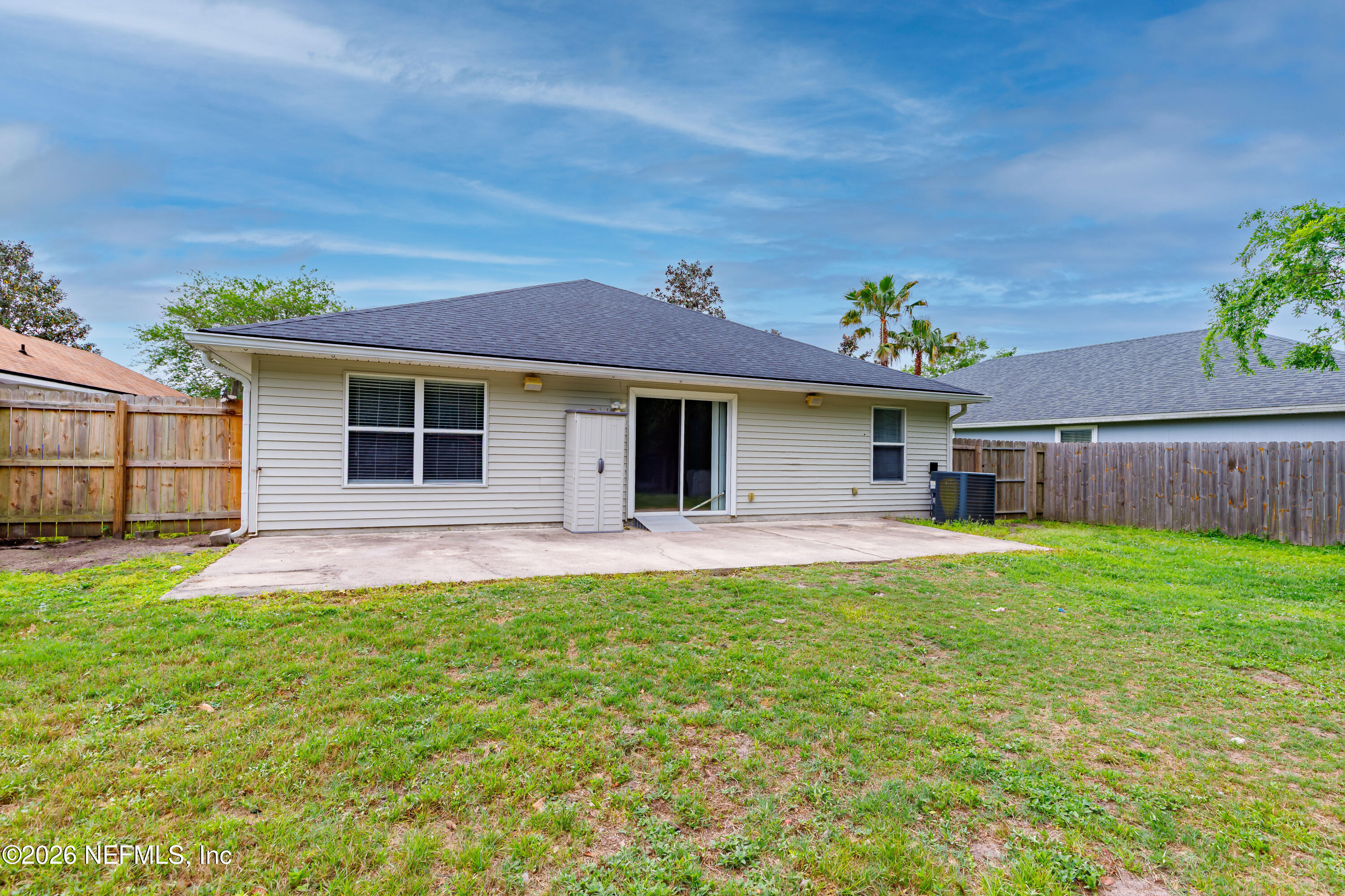 673 MacKenzie Circle St. Augustine, FL 32092 - Photo 26 of 28 a front view of a house with a garden and yard