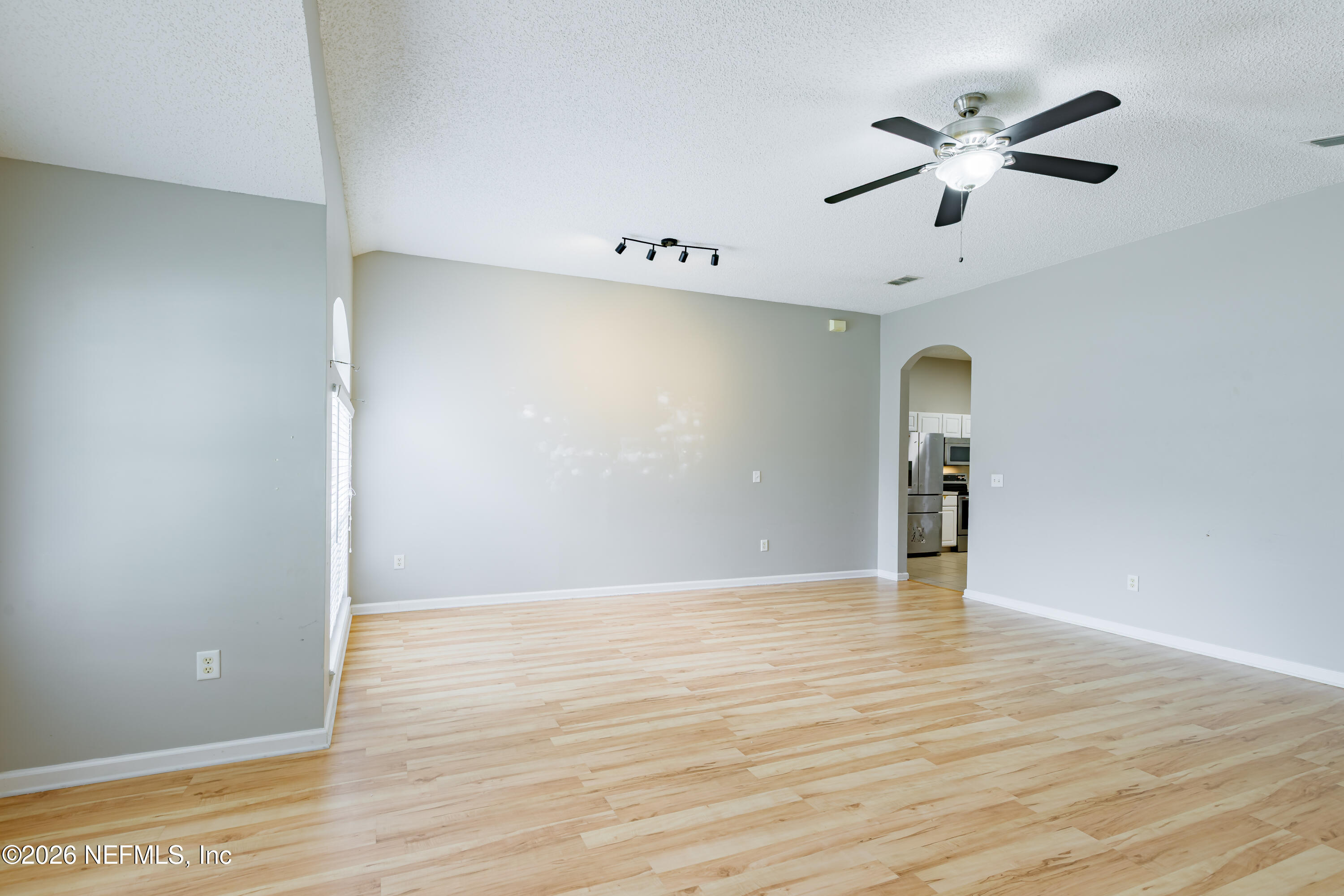 673 MacKenzie Circle St. Augustine, FL 32092 - Photo 4 of 28 an empty room with wooden floor and a ceiling fan