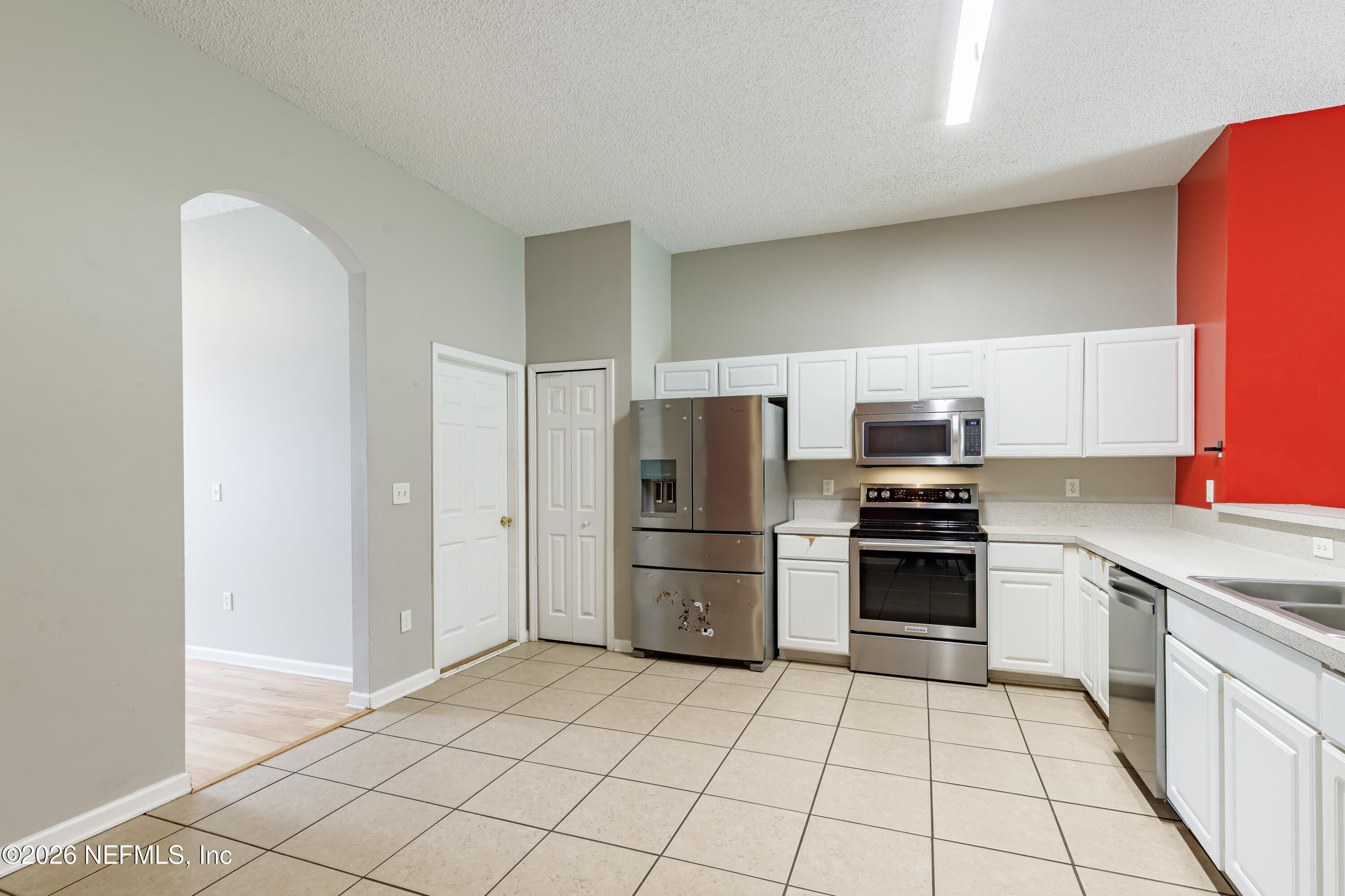 673 MacKenzie Circle St. Augustine, FL 32092 - Photo 7 of 28 a kitchen with stainless steel appliances a refrigerator sink and stove