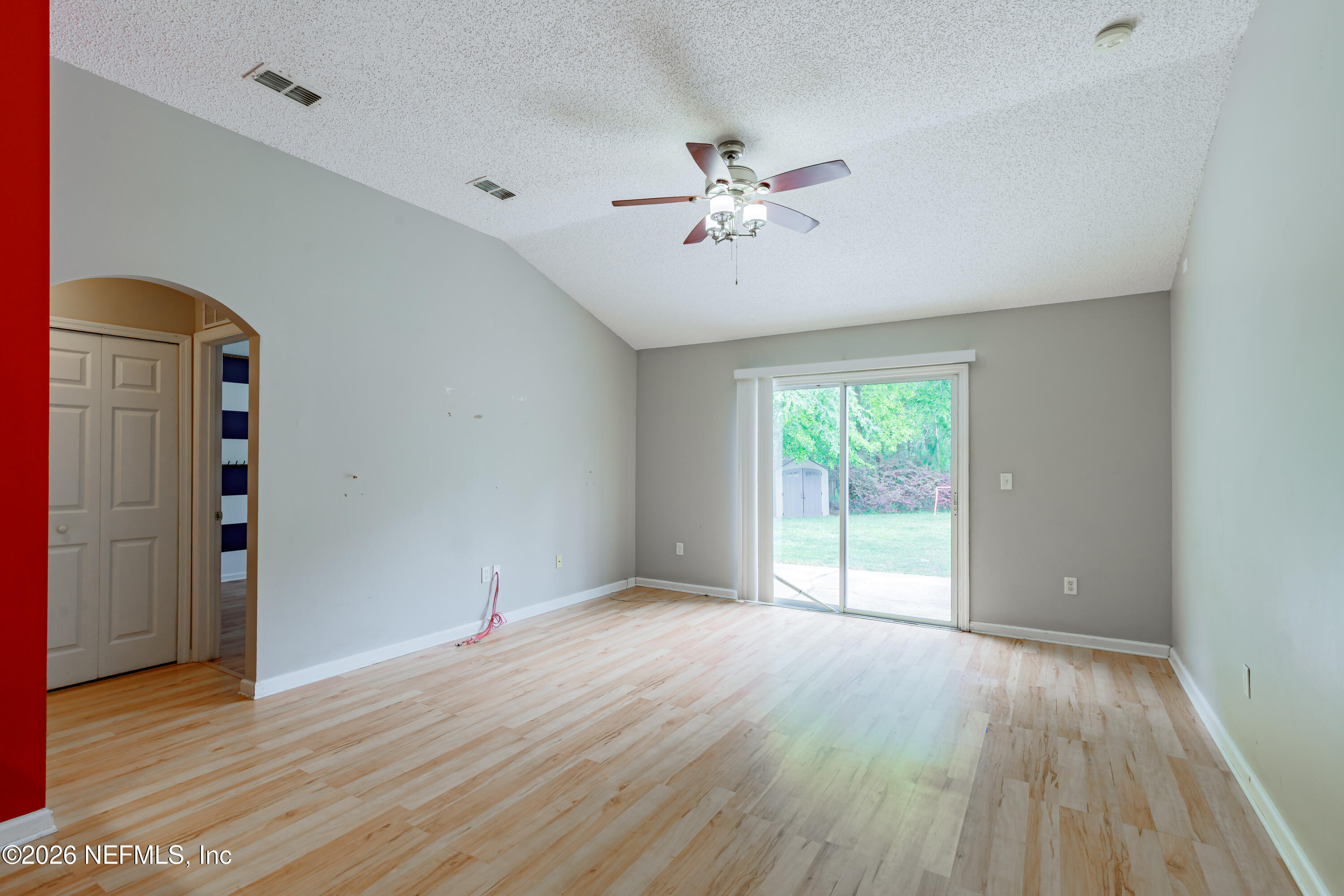 673 MacKenzie Circle St. Augustine, FL 32092 - Photo 9 of 28 a view of an empty room with wooden floor and a window