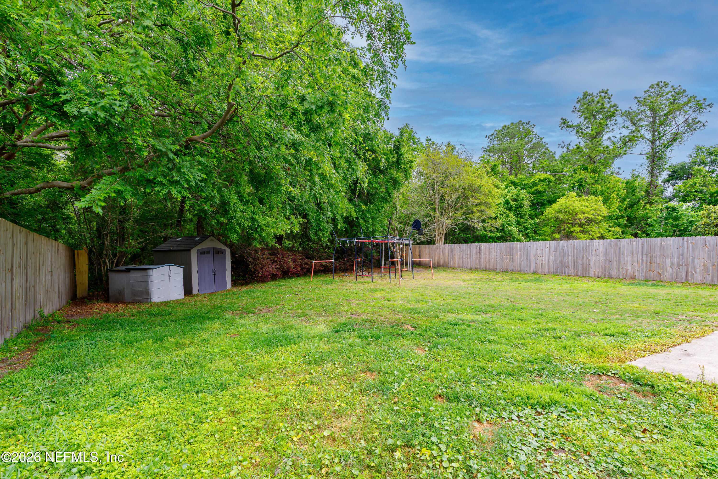 673 MacKenzie Circle St. Augustine, FL 32092 - Photo 10 of 28 a backyard of a house with lots of green space