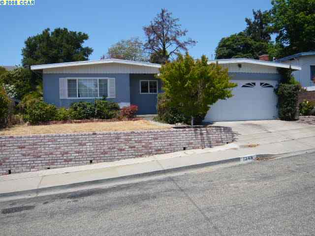 1348 Seventh Street Rodeo, CA 94572 - Photo 1 of 1 a front view of a house with a yard and a garage