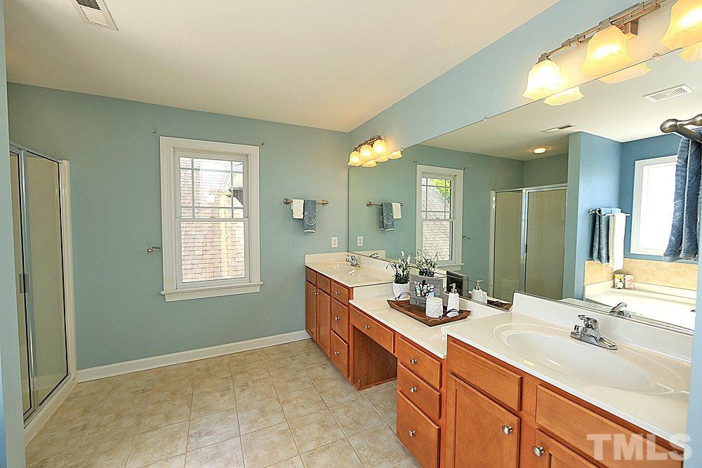 2108 Karns Place Raleigh, NC 27614 - Photo 12 of 26 a bathroom with double vanity sinks double vanity tub and a mirror