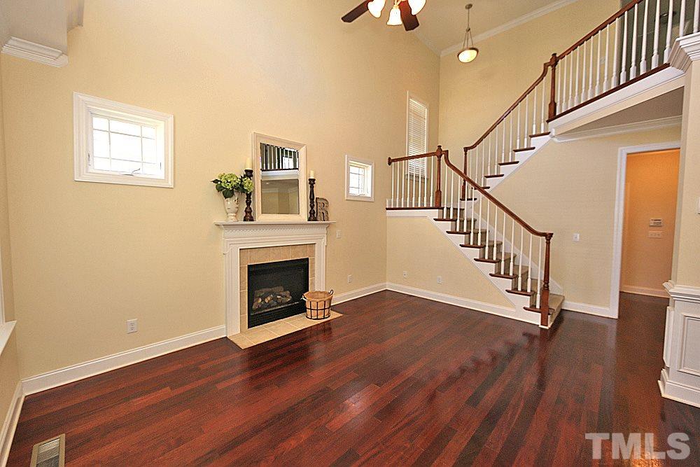 2108 Karns Place Raleigh, NC 27614 - Photo 4 of 26 a view of a livingroom with wooden floor and a fireplace