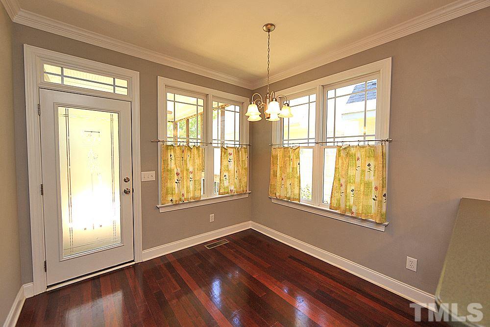 2108 Karns Place Raleigh, NC 27614 - Photo 10 of 26 a view of an empty room with wooden floor and a window
