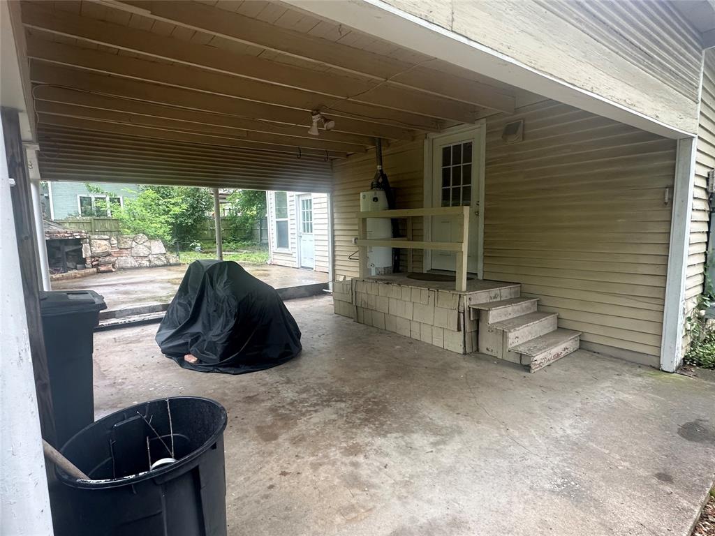 504 1st Street Terrell, TX 75160 - Photo 21 of 27 Covered carport featuring a concrete floor, exposed ceiling joists, and exterior siding