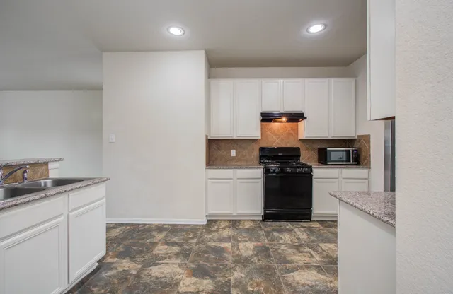 a kitchen with a stove and a refrigerator