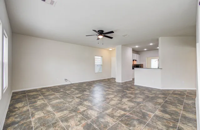 a view of a kitchen with a sink and a ceiling fan