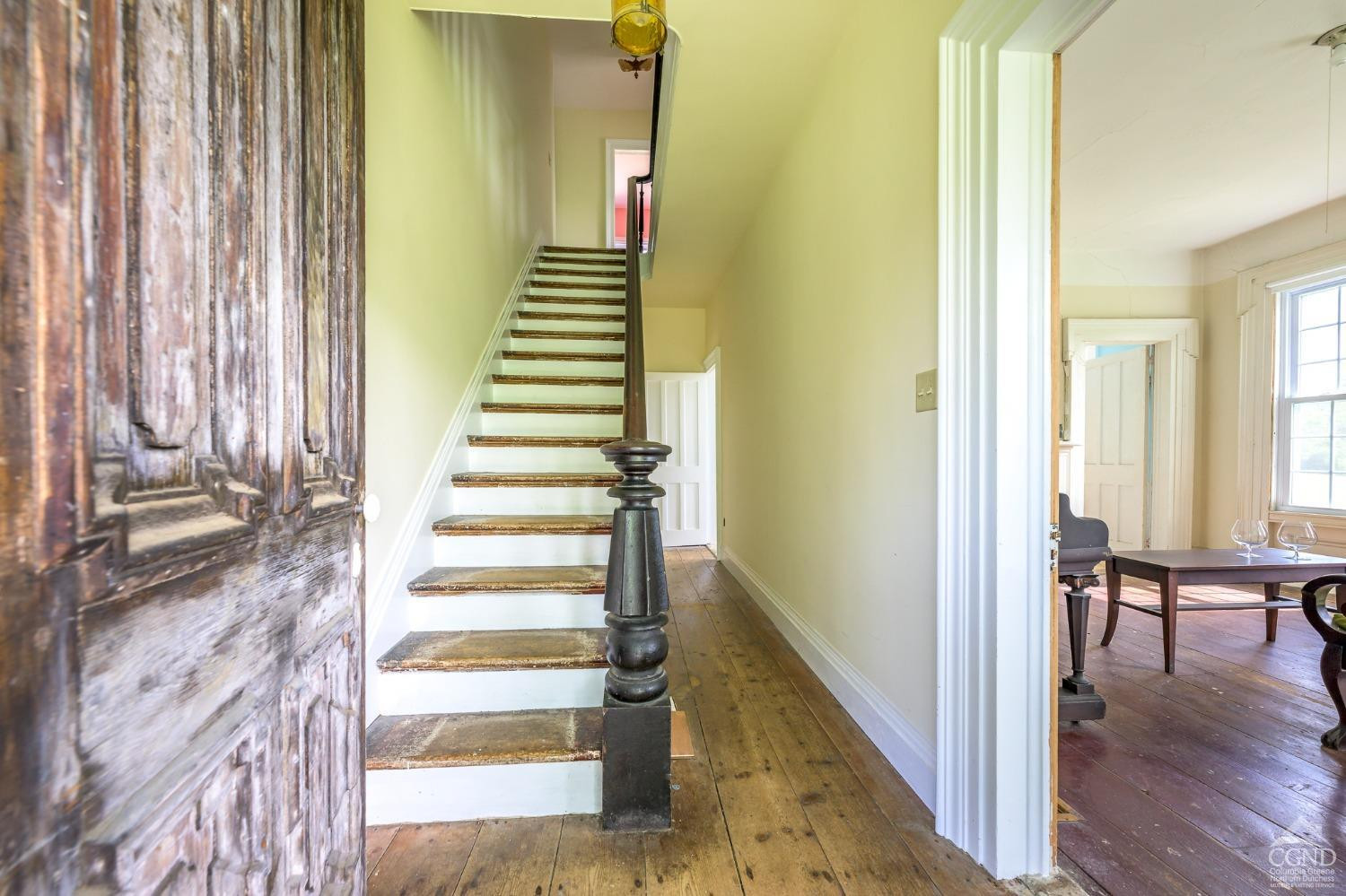 235 Slate Hill Road Ghent, NY 12037 - Photo 11 of 38 a view of a bedroom with wooden floor and stairs