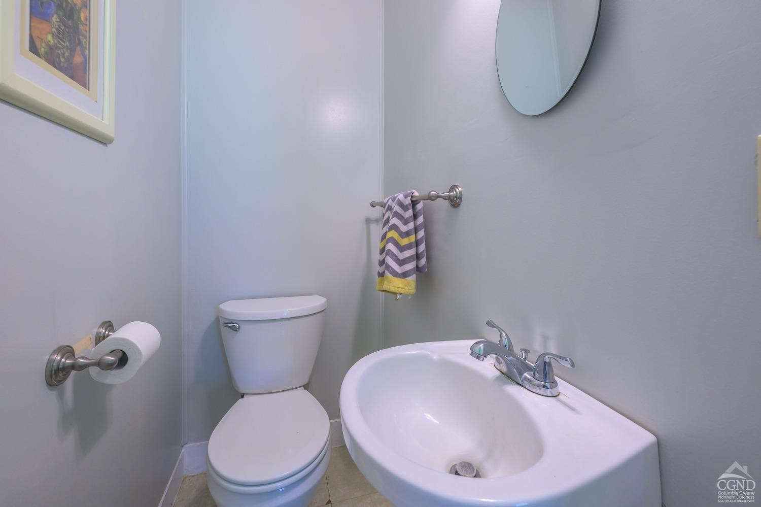 235 Slate Hill Road Ghent, NY 12037 - Photo 23 of 38 a bathroom with a sink a toilet and a mirror