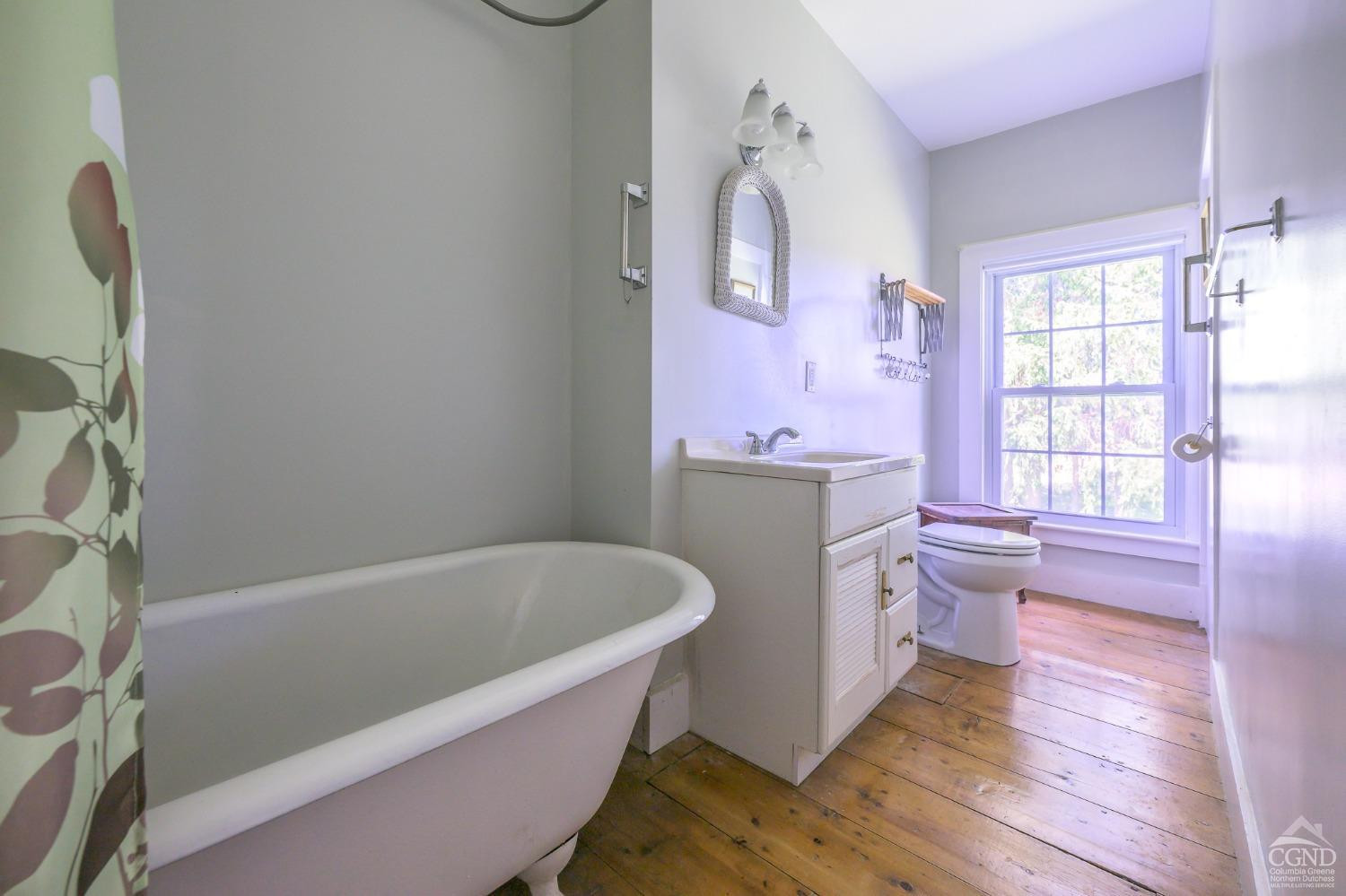 235 Slate Hill Road Ghent, NY 12037 - Photo 27 of 38 a bath room with a toilet and a bath tub