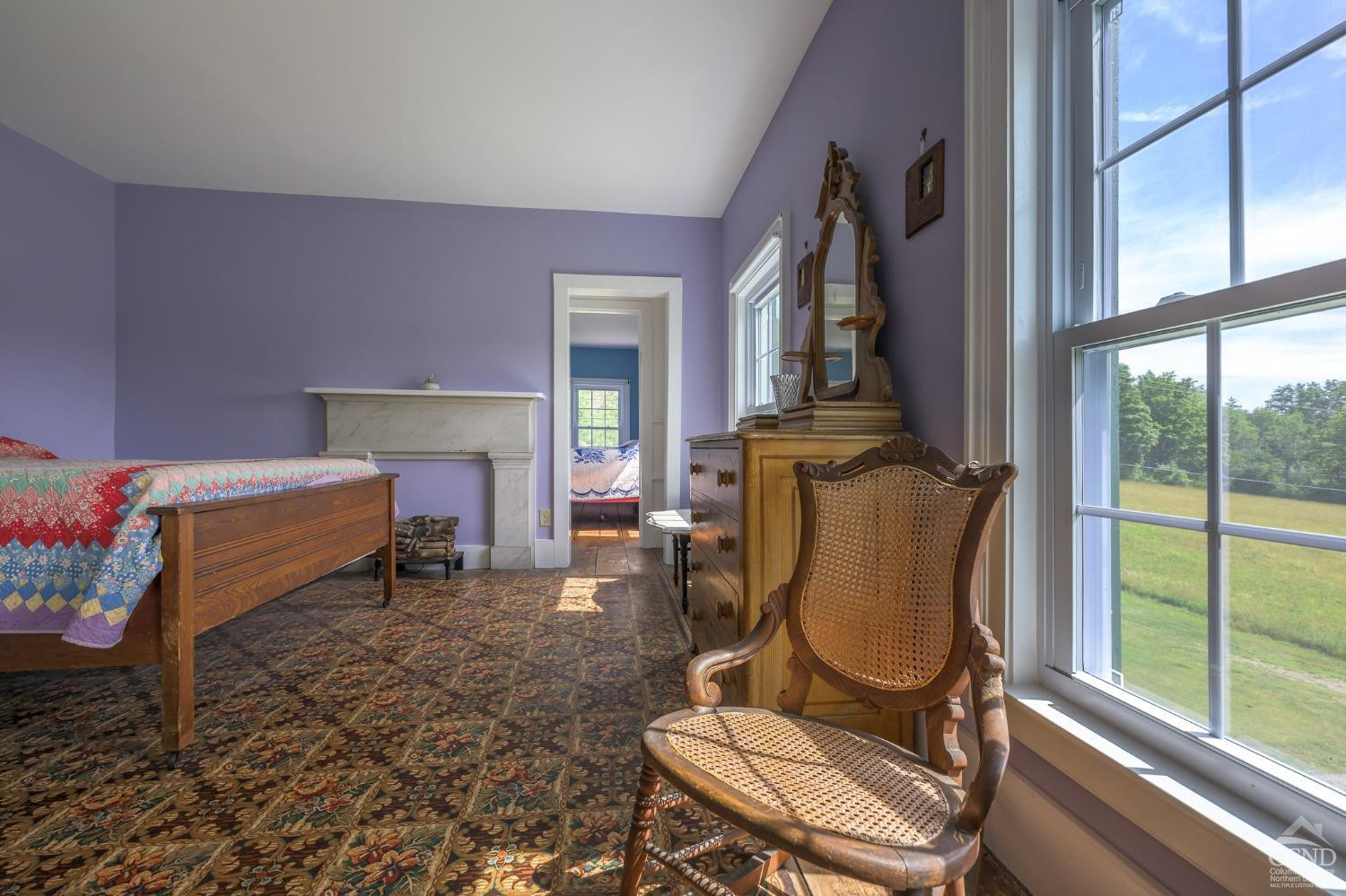 235 Slate Hill Road Ghent, NY 12037 - Photo 32 of 38 a living room with furniture a fireplace and large windows