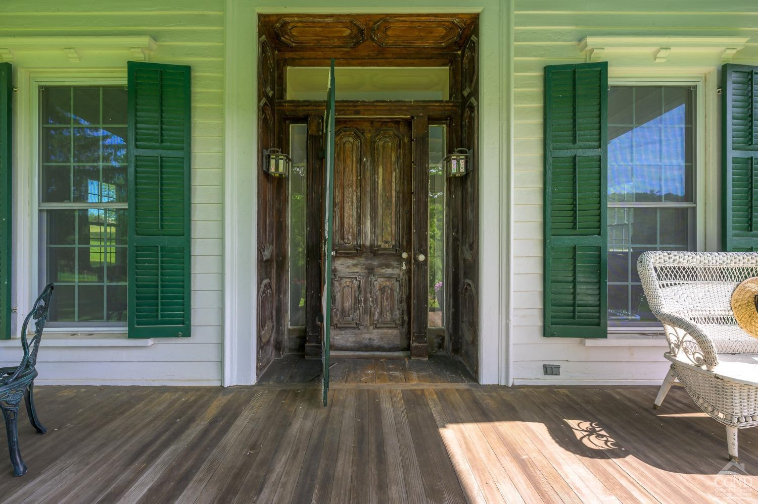 235 Slate Hill Road Ghent, NY 12037 - Photo 5 of 38 a view of a door with a chair and front door