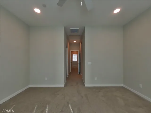 an empty room with closet area and mirror