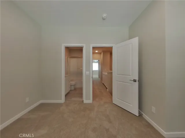 a view of an empty room and closet area