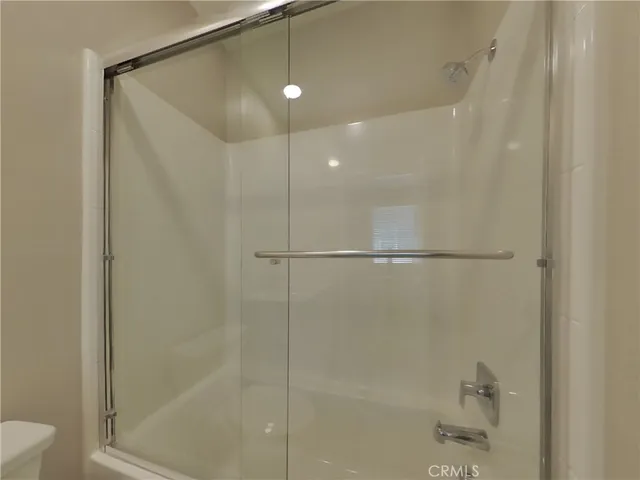 a bathroom with a shower and a glass door